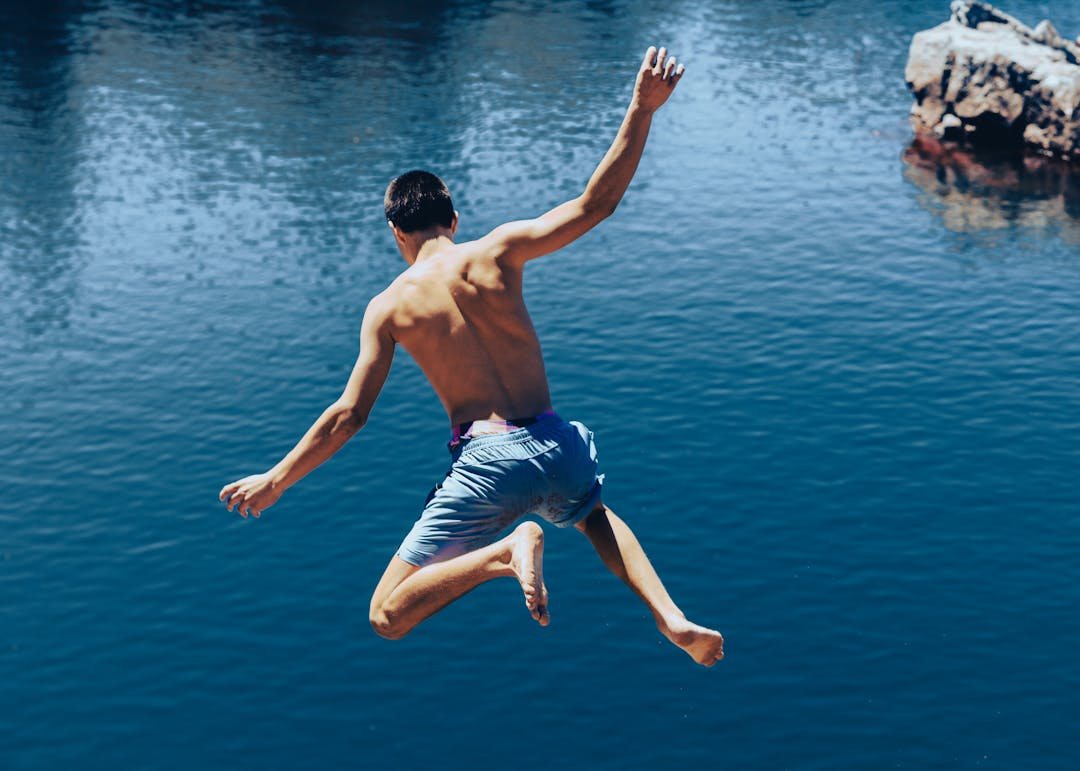 Youth in motion over water